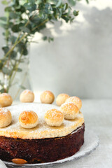 Easter cake simnel for breakfast on a grey background.