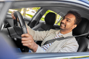 transport, vehicle and people concept - happy smiling indian man or driver driving car