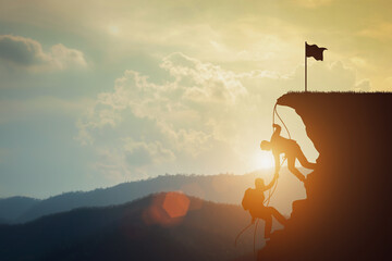 concept of teamwork makes a mission for success. Silhouette of businessman shake hands to up mountain with flags at the top in an area illuminated by sunset.