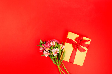 bouquet of flowers and gift box on floor