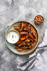 Honey garlic butter roasted carrots on a concrete background. Roasted carrots prepared with garlic butter and sweet honey sauce. Homemade glazed carrots