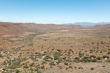 Fototapeta na wymiar Scene of a valley and mountains in the arid Karoo National Park, South Africa
