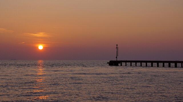 pier in the sunset at cinquale of montignoso in tuscany