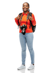 people, profession and photography concept - happy smiling woman photographer with digital camera and backpack over white background