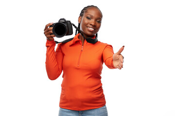 people, profession and photography concept - happy young woman with digital camera giving her hand for handshake over white background