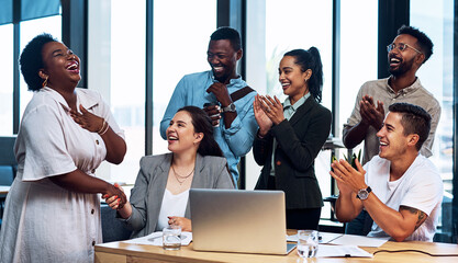 Sharing in each others achievements. Shot of a group of businesspeople applauding their colleagues...