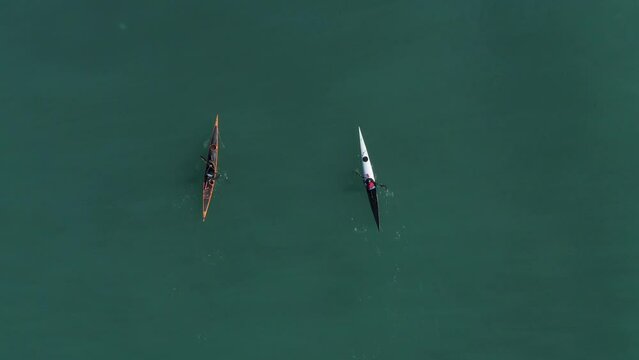 Single seat canoe rowing over a shallow lagoon, Aerial view.