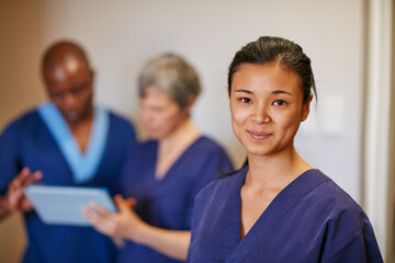 Helping people is so fulfilling. Cropped portrait of a female nurse standing in a hospital with her...