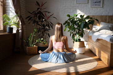 A woman doing yoga at home.