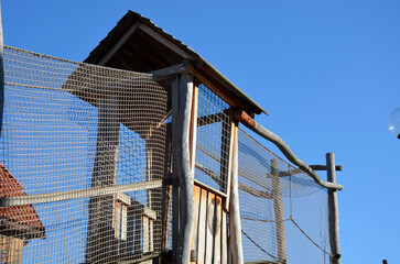 Fototapeta na wymiar high-rise children's house with bridges and footbridges for better safety, the whole game element is networked with a rope net. children cannot fall and injure themselves. reminds the aviary