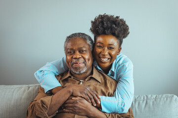 Afro hispanic-latino father and daughter together at home. Family is everything - Family Tie. Adult Daughter Hugging Senior Man. Senior black man and his middle aged daughter embracing, close up - obrazy, fototapety, plakaty