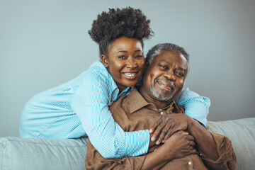 Adult daughter visits senior father in assisted living home. Portrait of a daughter holding her...