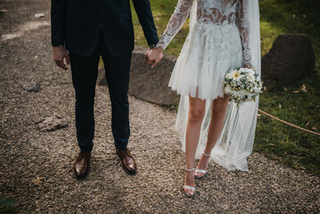 Newlywed romantic wedding couple walking. The bride and groom walk holding hands.