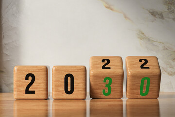 cubes with message 2022 and 2030 on wooden surface - obrazy, fototapety, plakaty