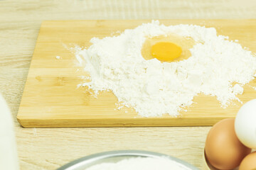 Fresh and raw chicken egg in flour