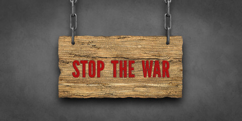 wooden sign with message STOP THE WAR on concrete background