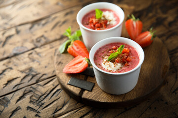 Homemade strawberry soup with chocolate and cream