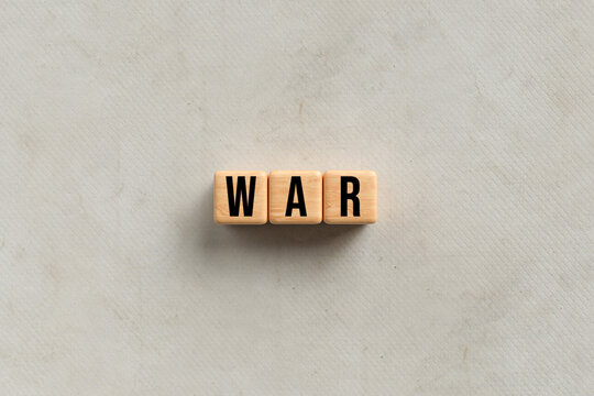 cubes with the word WAR on paper background