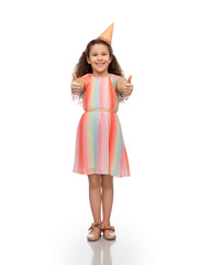 birthday, childhood and people concept - portrait of smiling little girl in dress and party hat showing thumbs up over white background