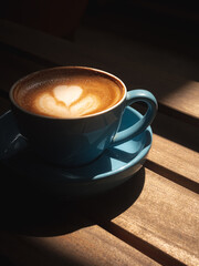 cup of coffee on the table with shadow