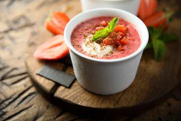 Homemade strawberry soup with chocolate and cream