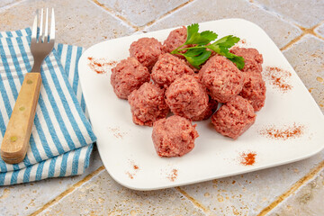 top view of raw beef dumpling in white plate