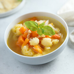 Homemade cauliflower soup with fresh basil