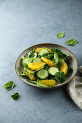 Healthy spinach salad with orange and cucumber