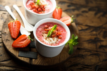 Homemade strawberry soup with chocolate and cream