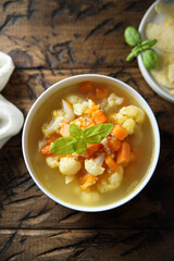 Homemade cauliflower soup with fresh basil