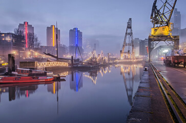 Rotterdam, The Netherlands, January 12, 2022: slowly dissappearing mist over Leuvehaven harbour on a morning in January