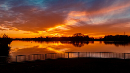 Naklejka premium Beautiful sunset with reflections near Plattling, Isar, Bavaria, Germany
