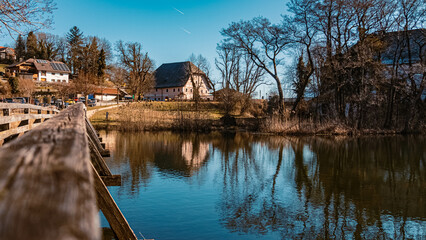 Beautiful winter wonderland with reflections at the famous Hoeglwoerther See lake, Hoeglwoerth, Bavaria, Germany