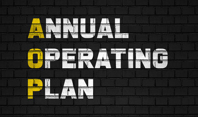 Fototapeta na wymiar Annual operating plan (AOP) concept,business abbreviations on black wall 