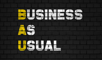 business as usual (BAU) concept,business abbreviations on black wall 