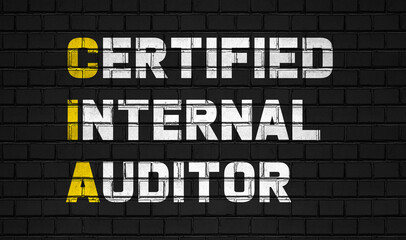 Fototapeta Certified internal auditor (CIA) concept,business abbreviations on black wall  obraz