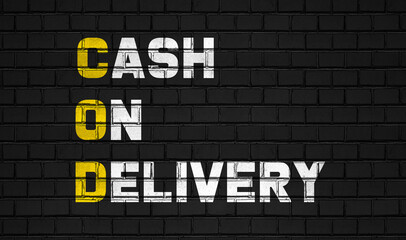 Cash on delivery (COD) concept,business abbreviations on black wall 