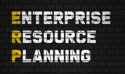 Enterprise resource planning (ERP) concept,business abbreviations on black wall 