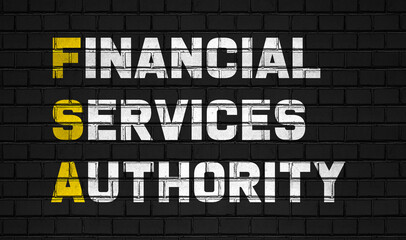 Fototapeta na wymiar Financial services authority (FSA) concept,business abbreviations on black wall 