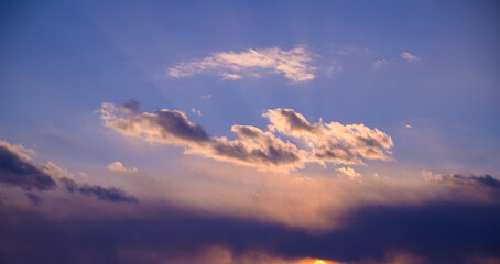 Dramatic sunset sky with orange colored clouds.