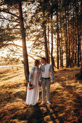 Fototapeta premium Bride and groom in Ukrainian national clothes. Wedding embroidered clothes. Wedding in the Ukrainian style. Happy bride in traditional Ukrainian embroidered dress. Ukrainian patriots