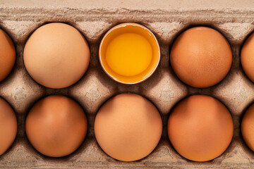 Fresh brown chicken eggs isolated on yellow table background.
