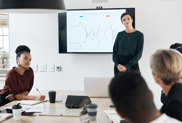 The monthly management meeting is in session. Shot of a group of businesspeople having a meeting in a modern office.