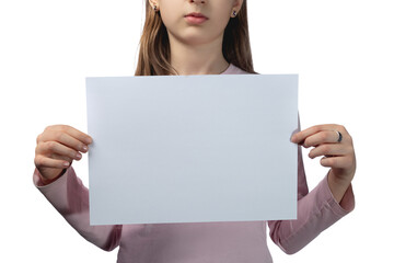 Fototapeta premium Little cute Ukrainian girl 11 years old posing in the studio on a white background. The child holds a blank white sheet in his hands. Preparation for the inscription.