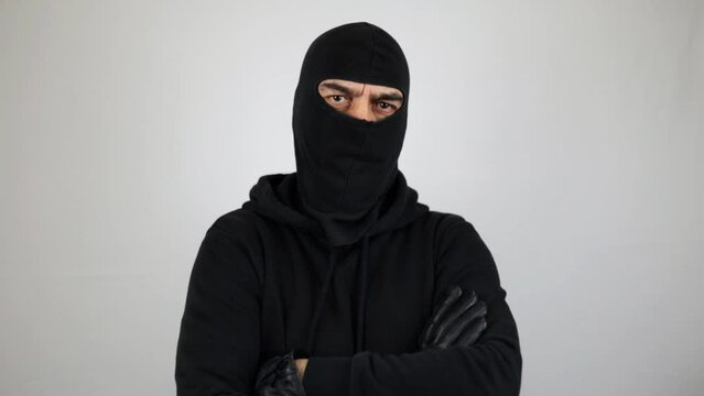 Portrait man with balaclava with crossed arms looking at the camera. Crime concept