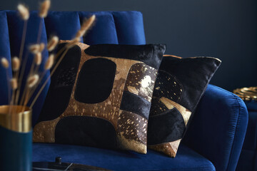 Stylish close up on the elegant pillow in the glamour living room interior. Golden home decorations...