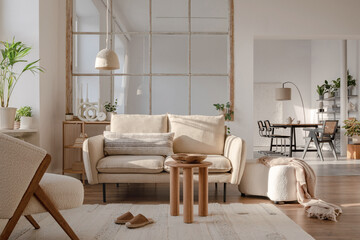 Fototapeta na wymiar Stylish compositon of modern living room interior with sofa, plants, wooden commode, side table and elegant home accessories. Home staging. Template. Copy space.