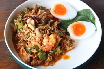 Hot Thai kitchen, Wing Bean Salad (Yum Tuapu) mix of shrimp ,boiled egg ,minced pork ,roasted cashew nut ,coconut milk ,lime juice ,fried shallot and wing bean.Popular Thai food dishes you must eat.  