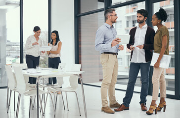 The biggest assurance of success is teamwork. Shot of a group of colleagues having a discussion in an office.