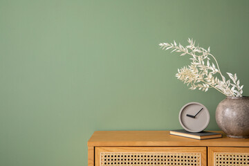 Creative bedroom interior composition with rattan commode, modern home decorations and personal...